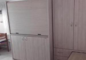 a kitchen with a white refrigerator in a room at Hotel Fotini in Kamena Vourla