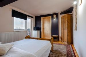 Postel nebo postele na pokoji v ubytování Pensiunea Bucovina