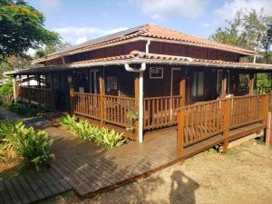 a wooden house with a large wooden deck at Pousada Seu Dodó in Fernando de Noronha