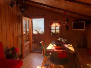 a room with a table and chairs in a cabin at Chalet Sappada in Sappada