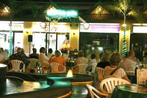 a group of people sitting in a restaurant at Windmill Resort Hotel Pattaya in Pattaya North