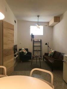 a living room with a couch and a table at APT Slow City Hostel in Pontevedra