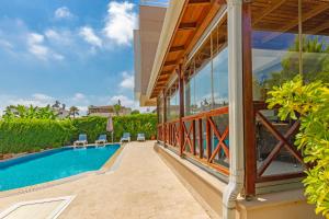 an external view of a house with a swimming pool at Paradise Town Villa Premium in Belek
