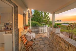 a kitchen and a patio with a table and chairs at Sea La Vie in Skala Rachoniou +25 photos