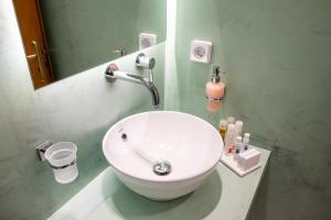 a bathroom with a white sink and a mirror at Tinos Koralli in Tinos Town