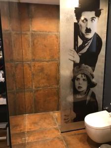 a bathroom with a shower with a picture of a man at Villa No 5 in Bodrum City