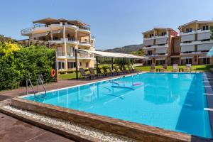 a large swimming pool in front of a building at Anilio Plaza in Zakharo