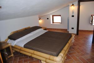 a bedroom with a large bed in a room at Il Giardino di Julia B&B in Tortora