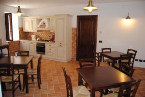 a kitchen and dining room with tables and chairs at Il Giardino di Julia B&B in Tortora +50 photos