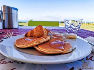 a plate of pancakes with peanut butter and jelly on a table at B&B L'EDEN DI CAPO BIANCO in Montallegro