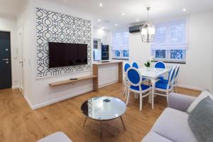 a living room with a couch and a table at Apartament w samym sercu Opola 3 in Opole