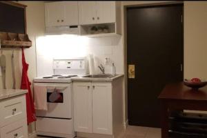 a kitchen with a white stove and a white refrigerator at Cozy Sweet #19. By Amazing Property Rentals in Gatineau