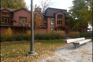 a pole and a bench in front of a house at Cozy Sweet #19. By Amazing Property Rentals in Gatineau