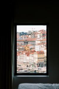 a window with a view of a city at Oh! Porto Apartments in Vila Nova de Gaia