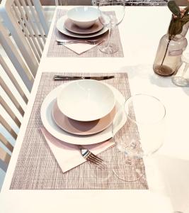a table with plates and glasses on top of it at Super Exclusive Bungalow in Benalmádena