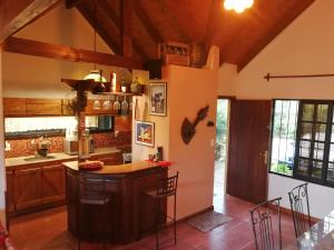 a kitchen with a island in the middle of a room at Cabaña Los Pololos in Villa Serrana
