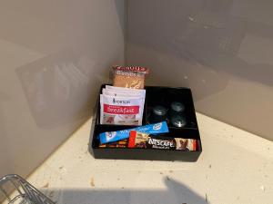 a box of food sitting on a counter in a refrigerator at Sandy Cove The Entrance Unit 16 in The Entrance
