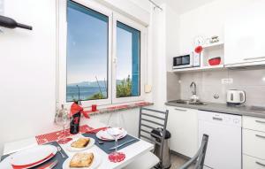 a kitchen with a table with food and a window at Roza in Rijeka