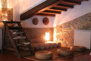 a living room with a ladder and a couch and stool at Agriresort La Noce di Francesca in Londa