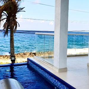 a swimming pool with a view of the ocean at CASA ENEIDA -SAN ANDRES ISLA in San Andrés