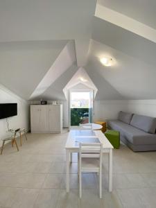 a living room with a white table and a couch at Luminus Apartments in Srima