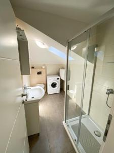 a bathroom with a shower and a sink and a toilet at Luminus Apartments in Srima +68 photos