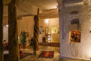 a living room with aamed ceilings and a large room with at Melek Cave Hotel in Goreme