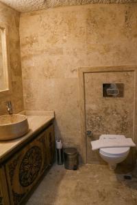a bathroom with a sink and a toilet at Melek Cave Hotel in Goreme