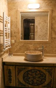 a bathroom with a sink and a mirror at Melek Cave Hotel in Goreme