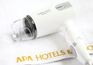 a close up of a hair dryer on a white table at APA Hotel Yodoyabashi Kitahama Ekimae in Osaka