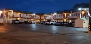 a parking lot in front of a hotel at night at Stagecoach Motel in La Junta