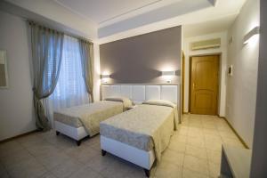 Postel nebo postele na pokoji v ubytování Artemisia Palace Hotel