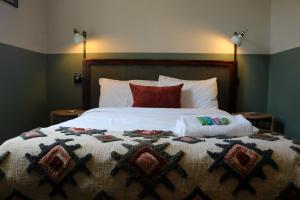 a bedroom with a bed with two pillows on it at Darlo Bar Darlinghurst in Sydney