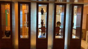 a display case in a museum with vases on display at Al SADIRGROUP AT TIME SQAURE in Kuala Lumpur