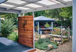 a garden with a wooden fence and a gazebo at Edlin House in Bright