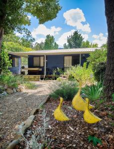 three fake bananas in front of a house at Edlin House in Bright