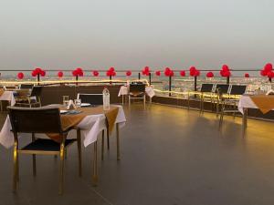 a restaurant with tables and chairs and red umbrellas at Ebony Boutique Hotel in Hyderabad