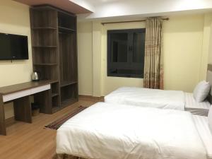 Voodi või voodid majutusasutuse Ngoc Tran Hotel toas