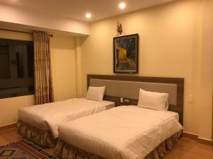 Voodi või voodid majutusasutuse Ngoc Tran Hotel toas