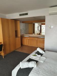 a hotel room with a bed and a table at Capital Airport Motel in Queanbeyan
