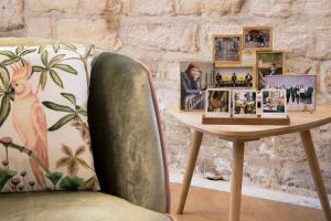 a table with pictures on it next to a chair at Hôtel des Arts Montmartre in Paris