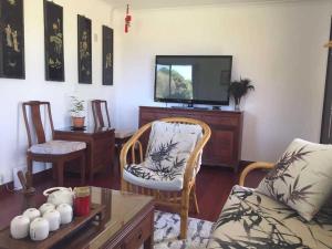 ein Wohnzimmer mit einem Sofa und einem TV in der Unterkunft Eden Nimo Motel in Eden