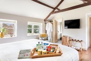 a bedroom with a bed with a tray of food on it at Shoulder of Mutton Inn in Harrogate