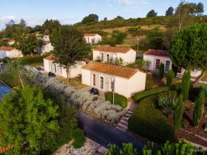 an aerial view of a house with a river at Olydea Les Epesses in Les Épesses