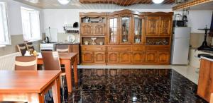a kitchen with wooden cabinets and a counter top at Hotel Devino in Kutaisi