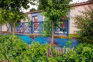 a house with blue paint on the front of it at Hôtel Olydea Les Epesses - à 2,5km du PuyDuFou in Les Épesses