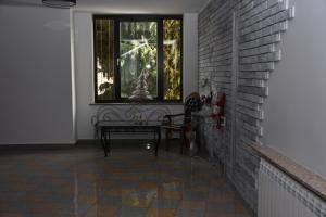a window in a room with a bench and a table at Dom Przyjęć Pradziad in Rogów