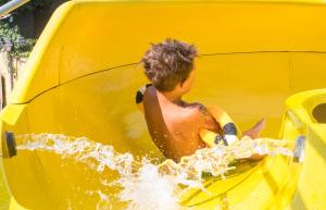 a young boy playing on a water slide at Hotel Fabrizio in Rimini
