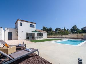 a villa with a swimming pool and a house at Holiday Home Beaufort with Private Pool in Beaufort