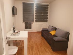 a living room with a couch and a table at Apartman Dunjica in Pale